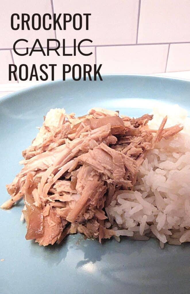 Closeup of plate with pork and rice and text crockpot garlic roast pork.
