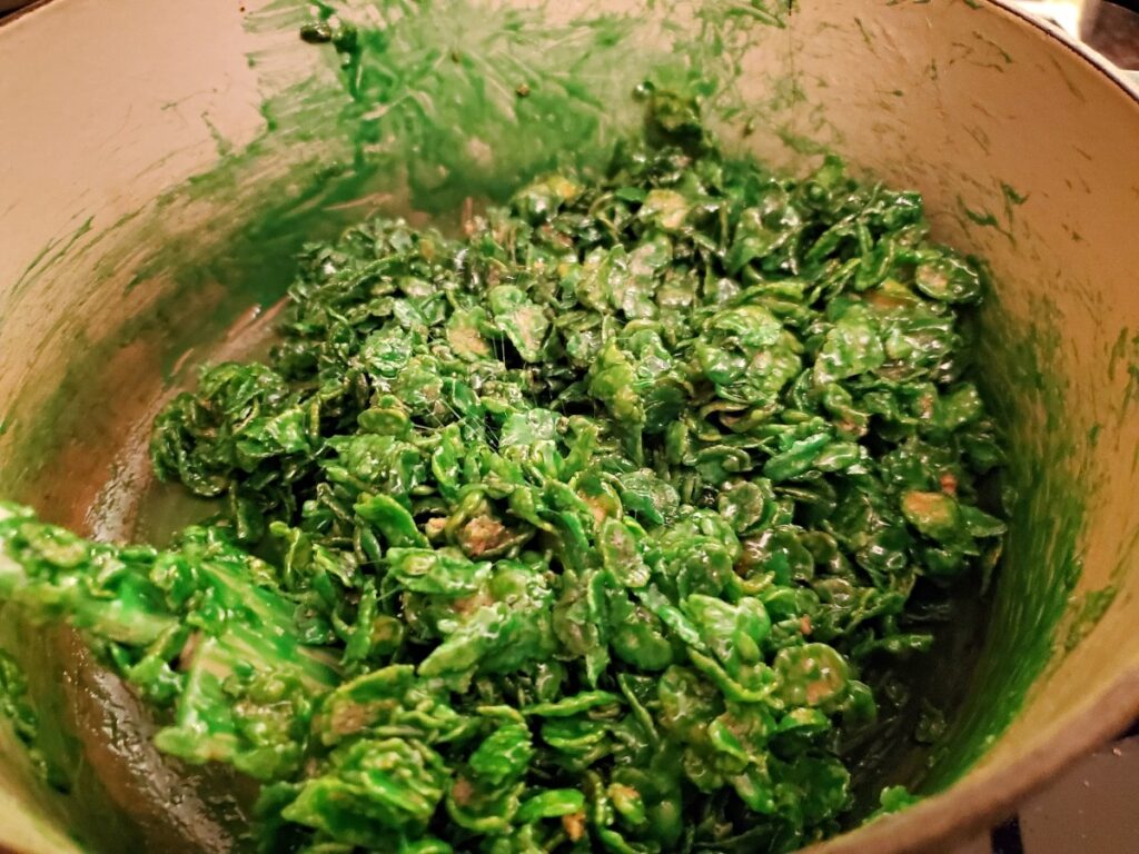 Corn flakes covered in green marshmallow goo.