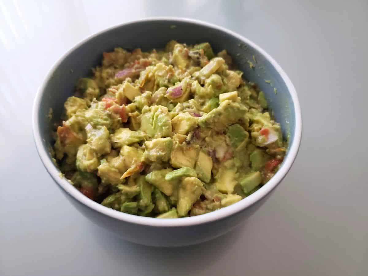 Image shows chunky guacamole in a bowl.