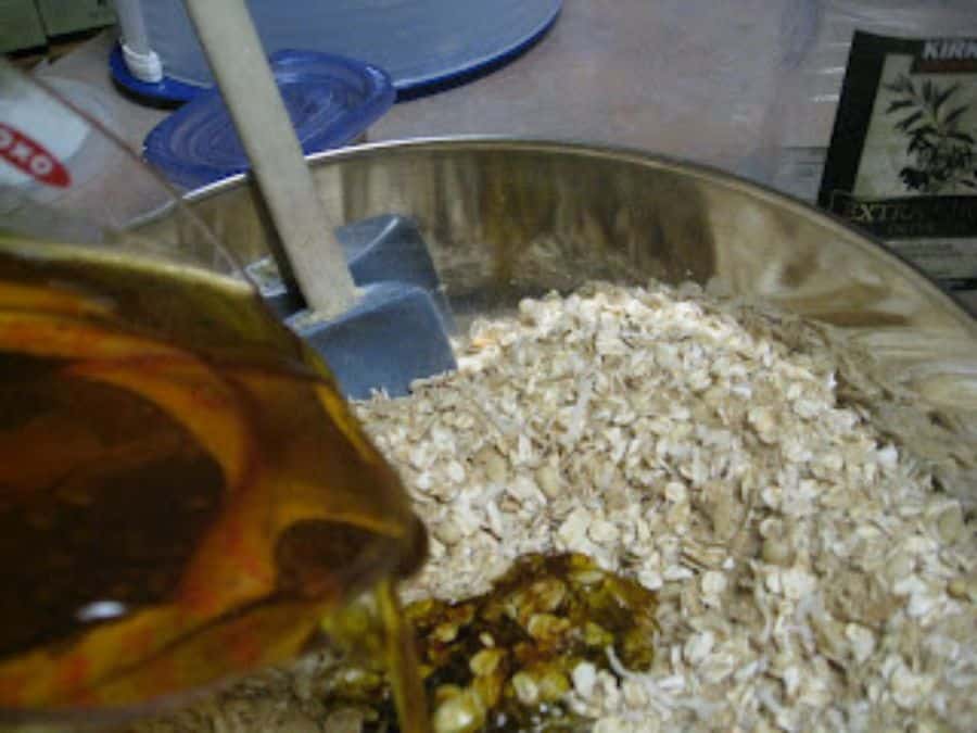 Image shows wet ingredients of homemade granola mixed together in a bowl.