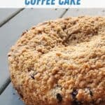 Closeup of whole coffee cake on blue wood table.