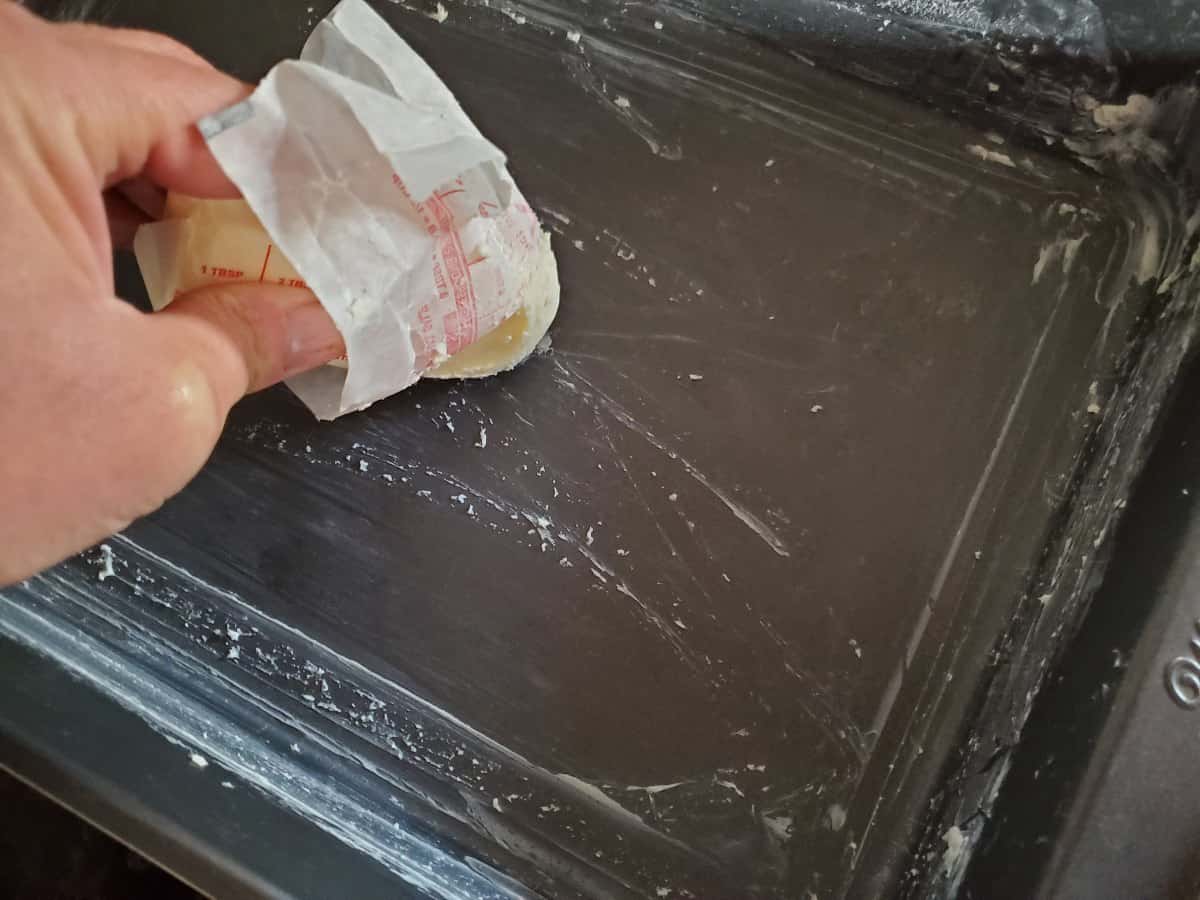 Buttering a 9x13 pan.