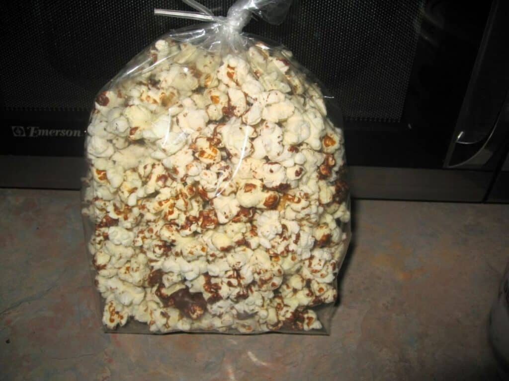 Image shows popcorn in a plastic container.