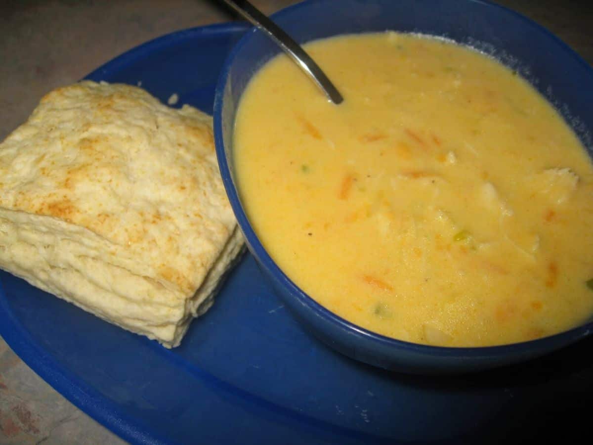 Image shows cheesy chicken soup in a bowl.