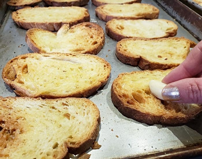 Rub garlic on crostini