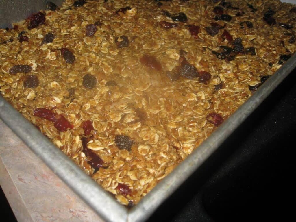 Image shows granola bars in a baking pan.