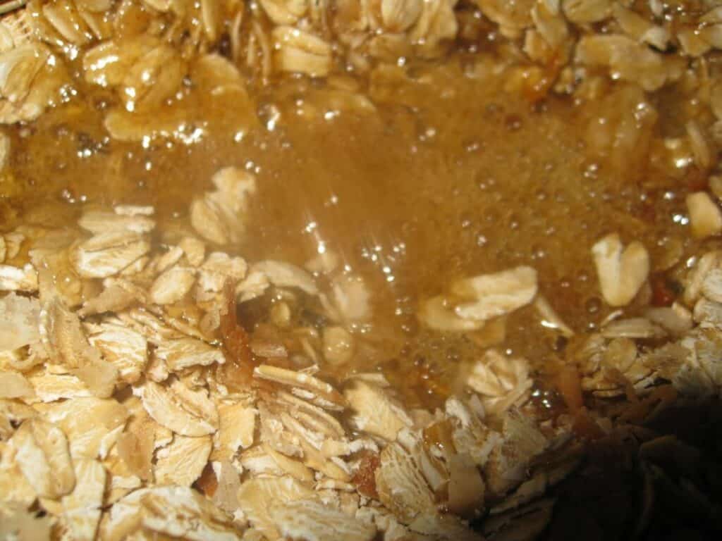 Image shows heated honey mixture in the center of the dry ingredients.