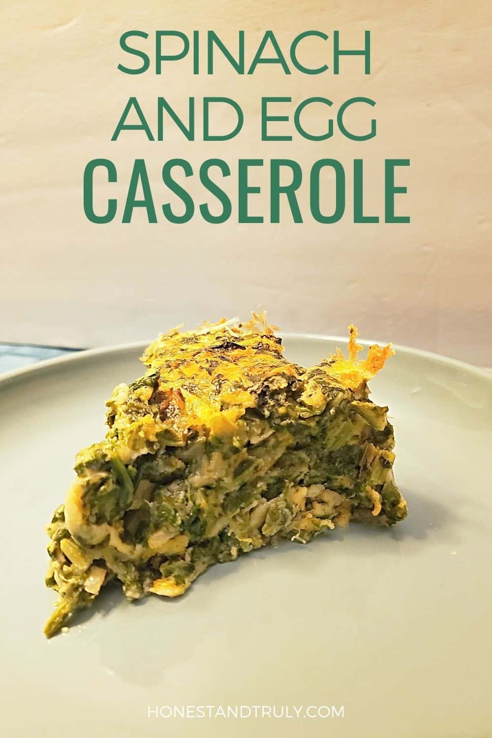 Plate of a slice of spinach souffle with text spinach and egg casserole.