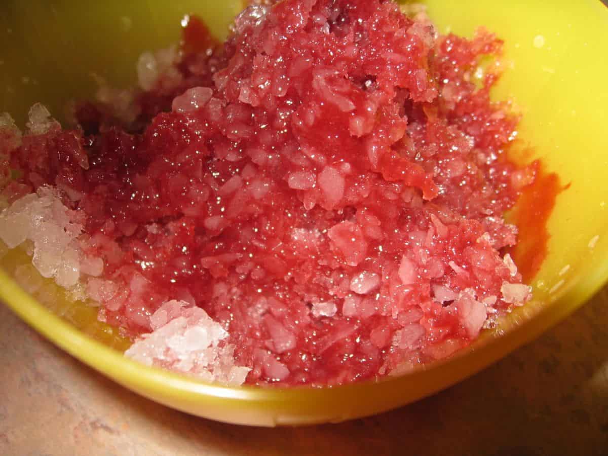 Image shows shaved ice topped with homemade red snow cone syrup.