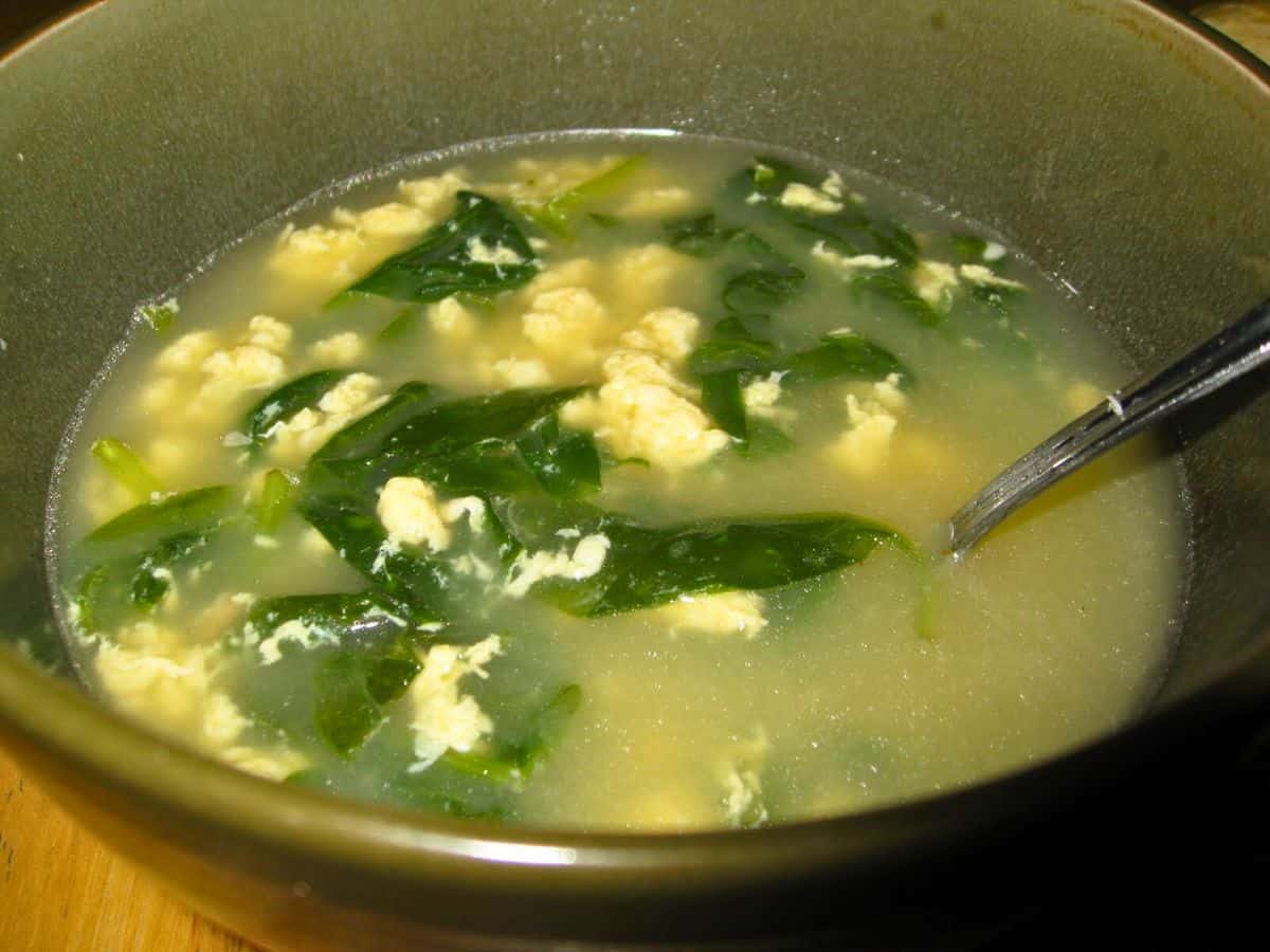 Image shows stracciatella soup in a bowl.