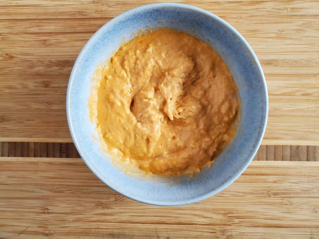 Image shows buffalo chicken dip in a bowl.