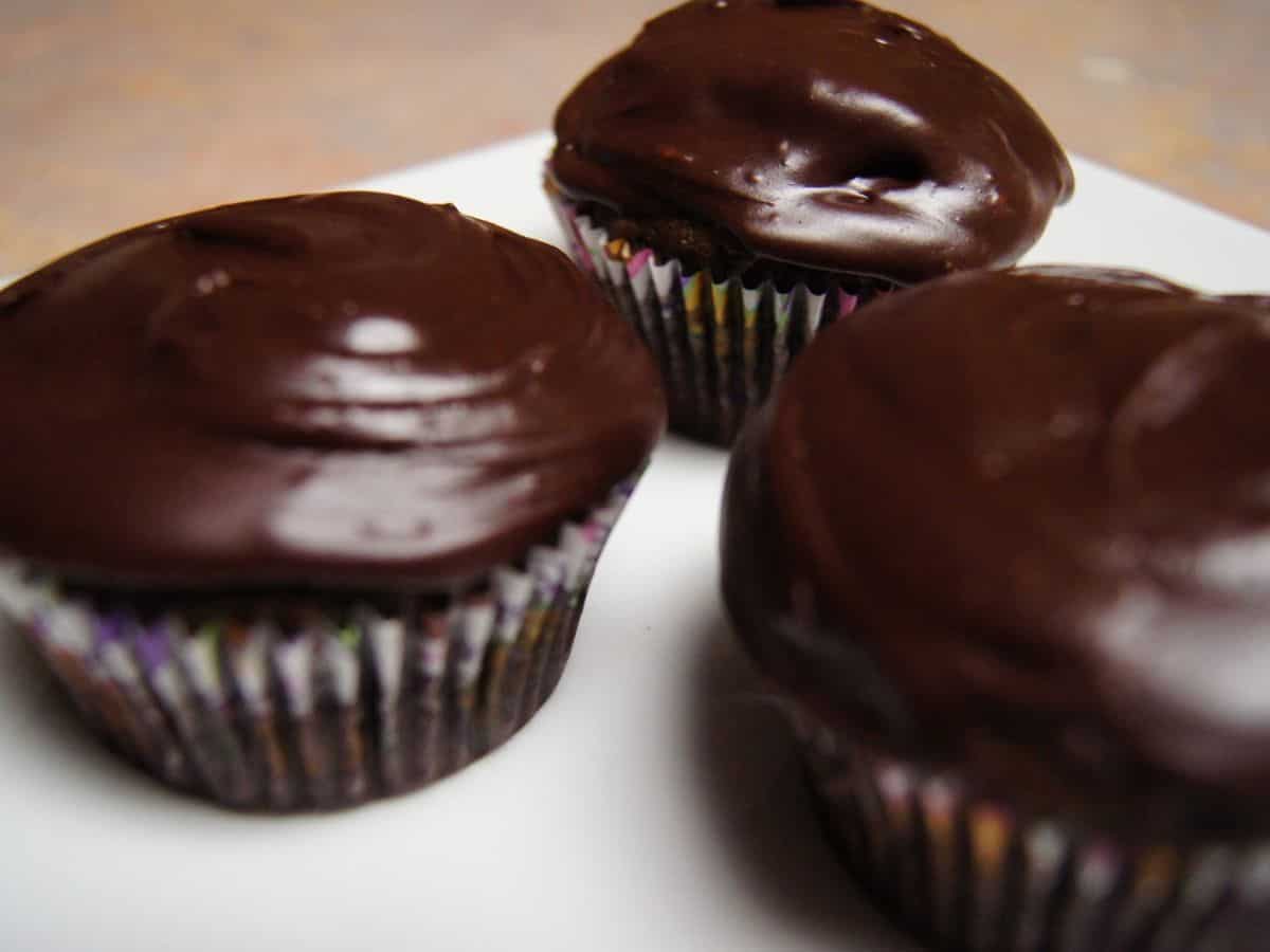 Image shows chocolate cinnamon cupcakes frosted with chocolate ganache.