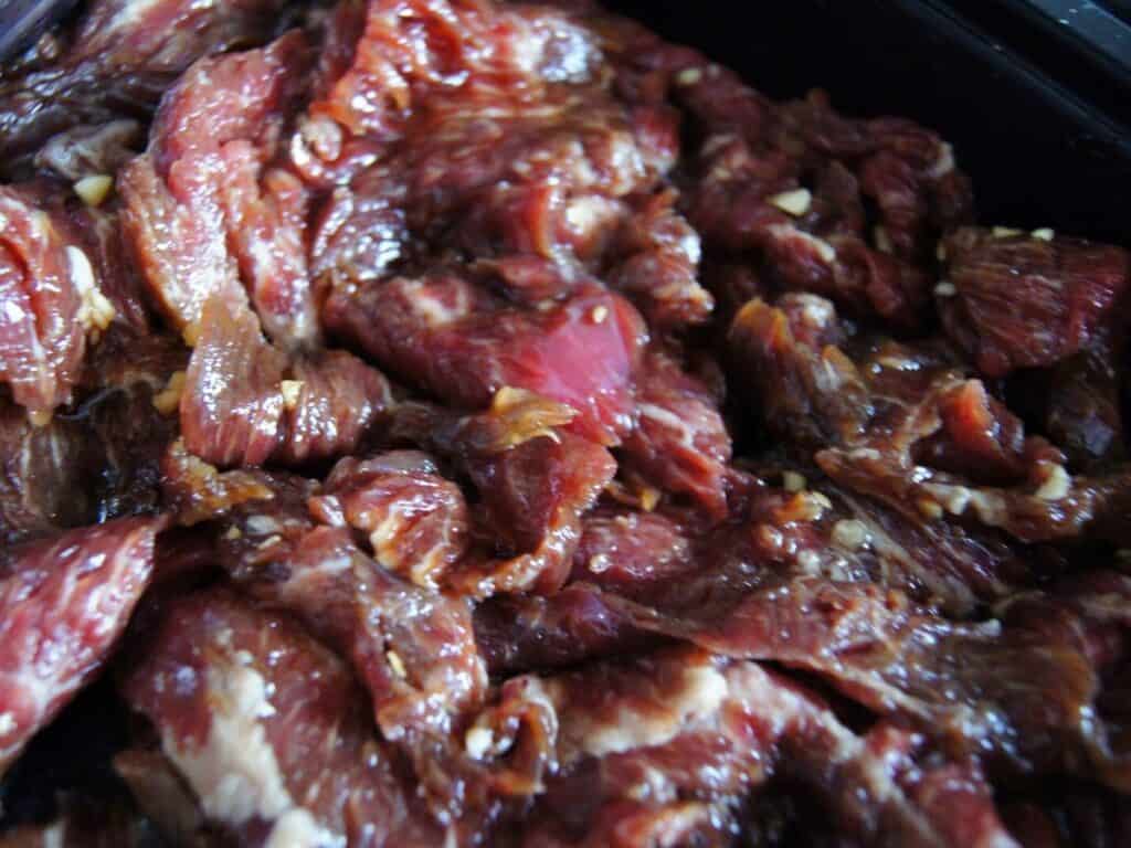 Image shows marinated beef.