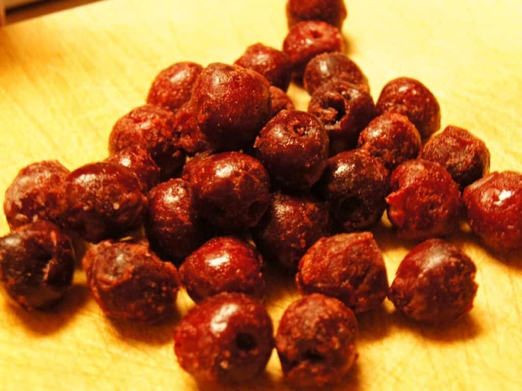 Image shows cherries on the chopping board.