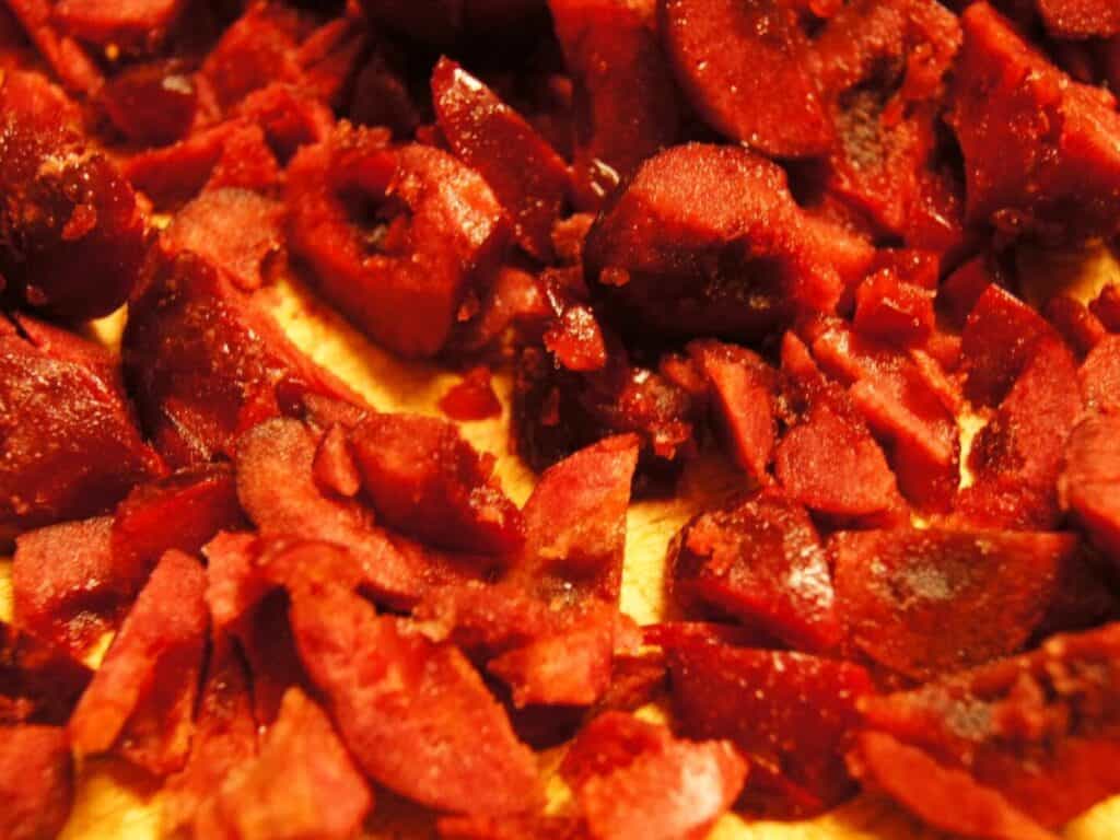 Image shows chopped cherries on the chopping board.