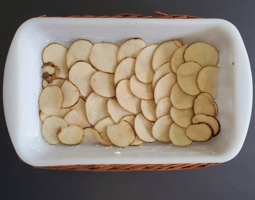 Potatoes layered in a casserole dish