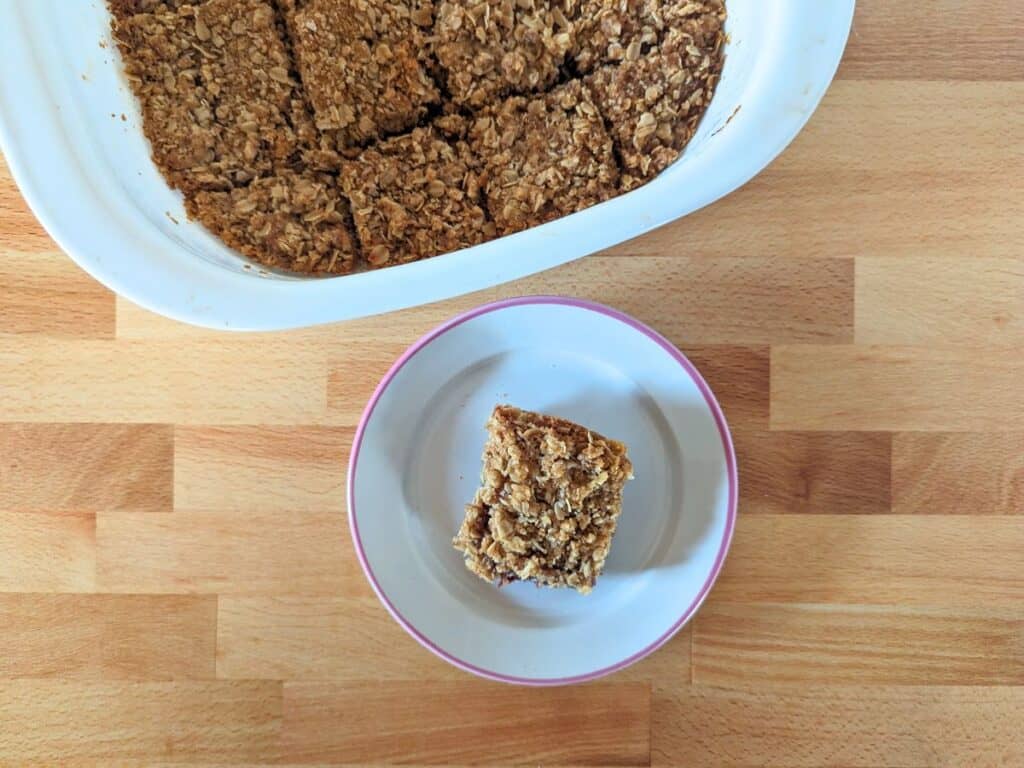 Image shows an Overhead of a raspberry jam bar on a plate.