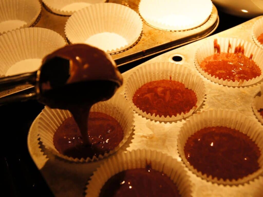 Image shows batter put into the muffin cups.