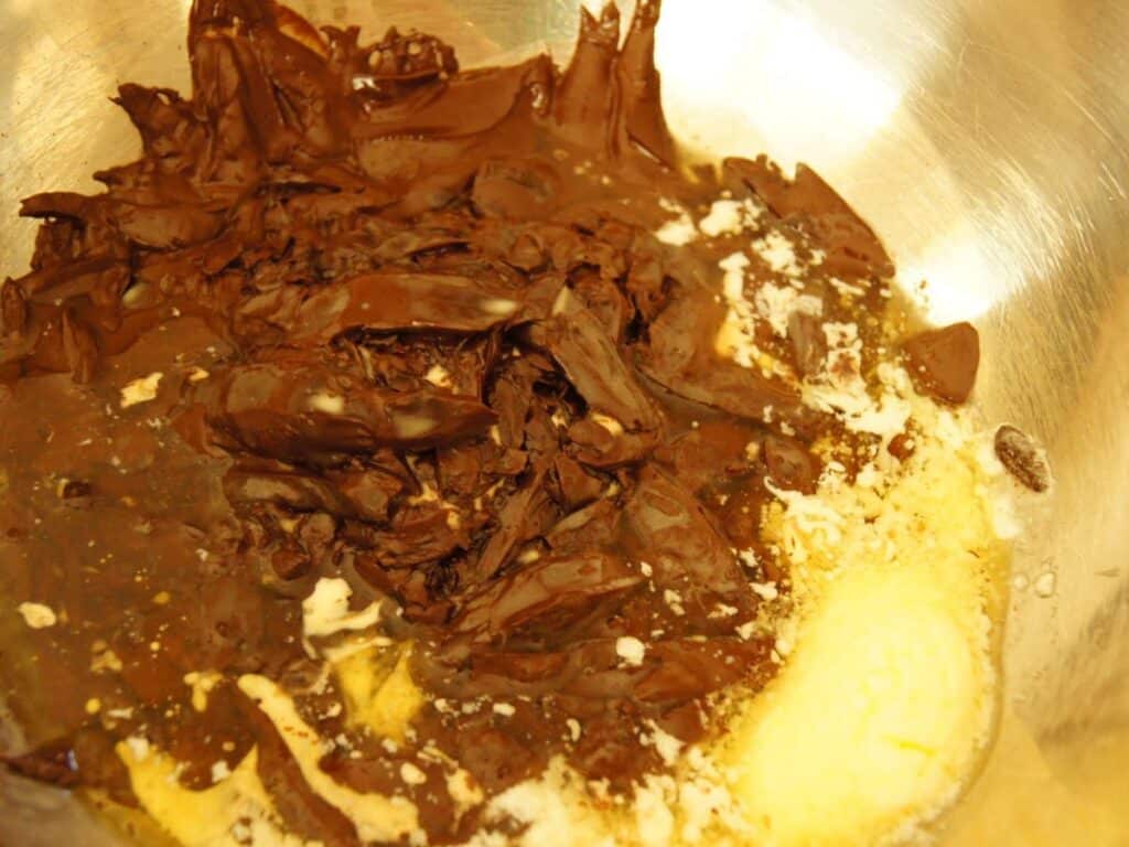 Image shows chocolate, butter, and cream melting together.