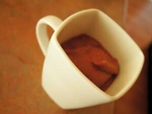 Image shows chocolate cherry smoothie in a cup.