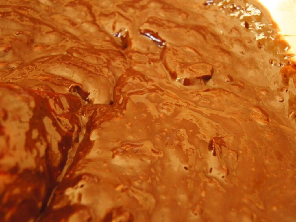 Image shows melted chocolate, butter, and cream.