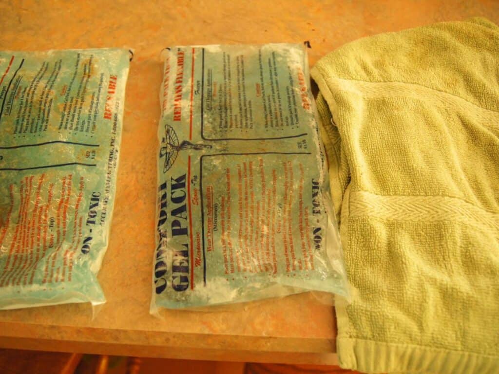 Image shows two ice packs and a towel.