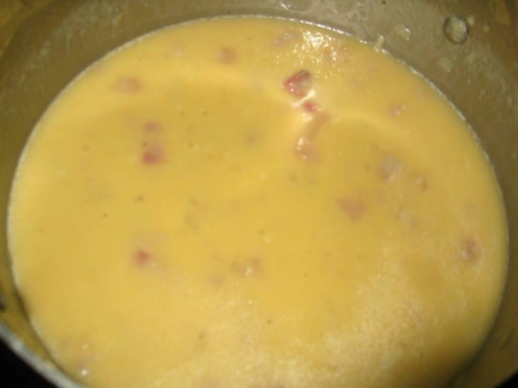Image shows carbonara sauce in a bowl.