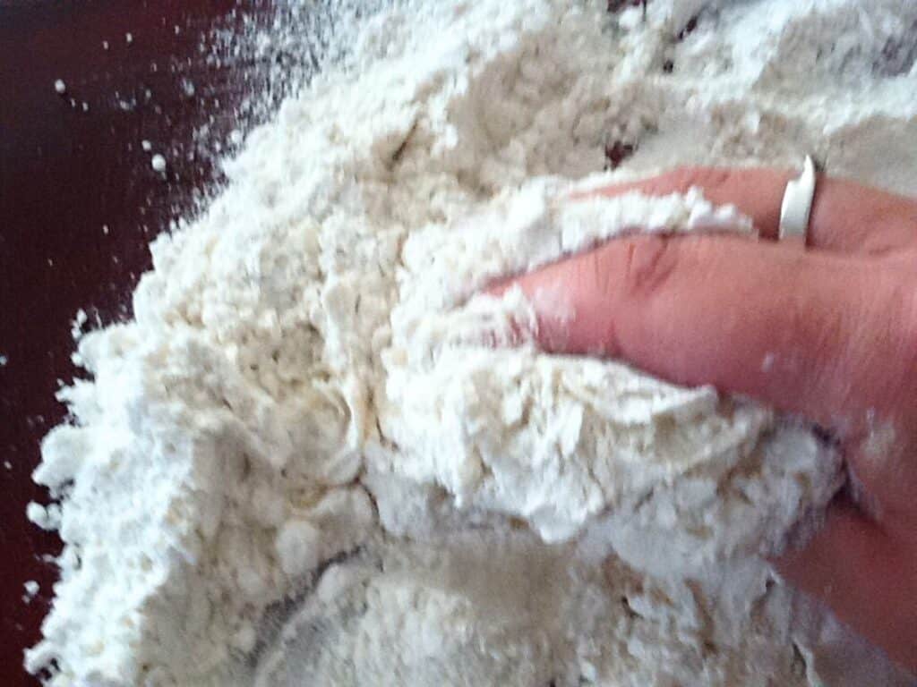 Image shows kneading the pasta dough.