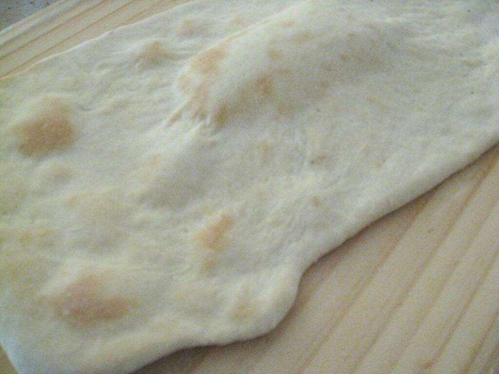 Image shows cooked pizza crust.