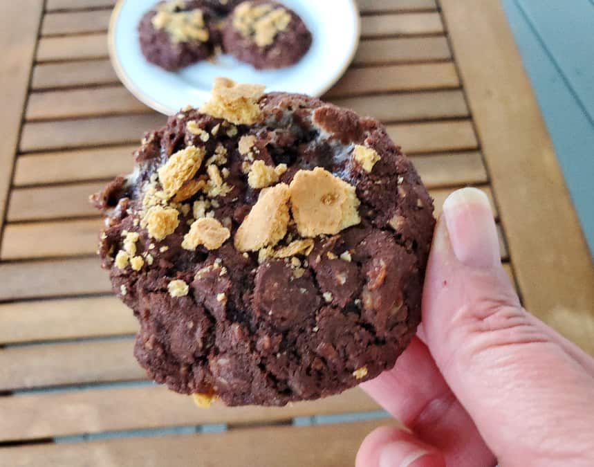 Holding a chewy smores cookie over a plate of others