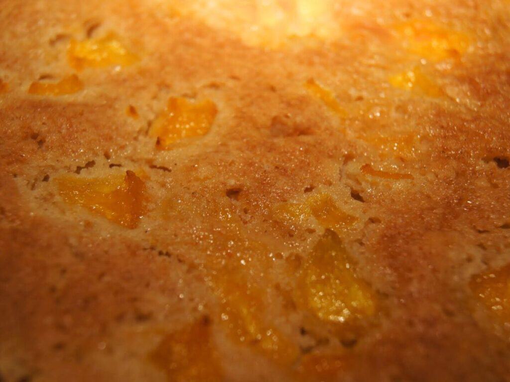 Image shows a close-up picture of peach cake.