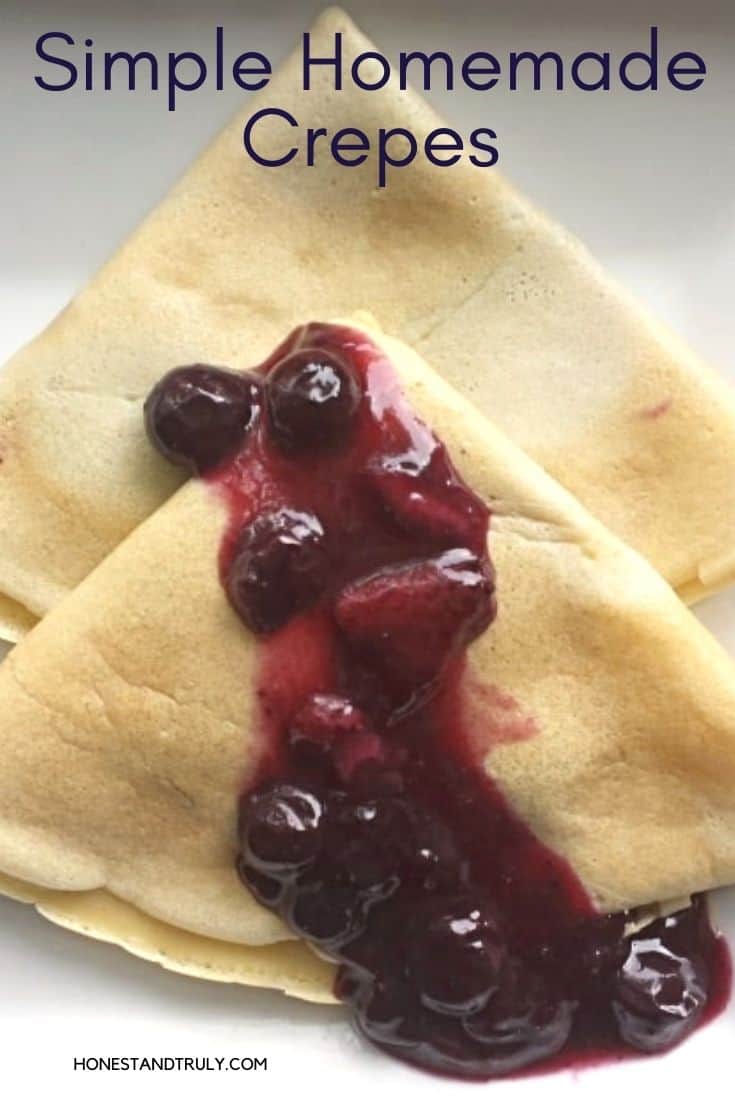 Plate of crepes with blueberry sauce