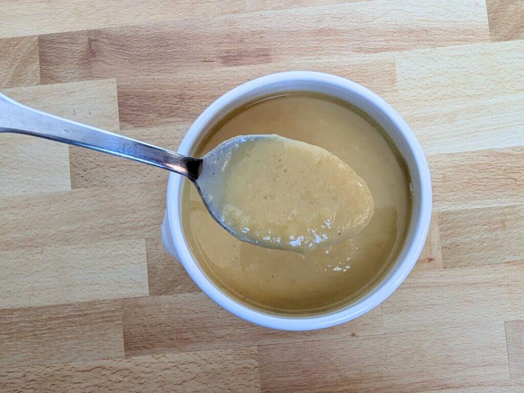 Image shows overhead view of the spoonful of yummy roasted butternut squash soup.