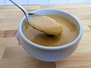Image shows spoonful of roasted butternut squash soup.