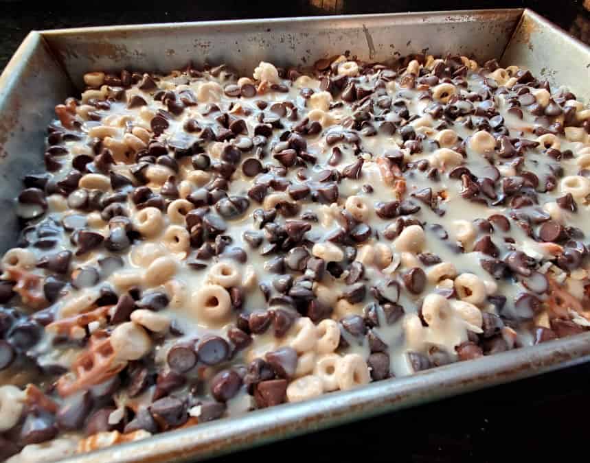 Sweetened condensed milk over cereal mixture in a pan