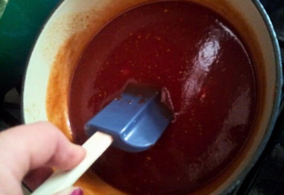 Image shows homemade BBQ sauce in a saucepan.