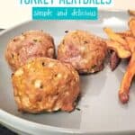 Closeup of a plate with three meatballs and text baked turkey meatballs simple and delicious.