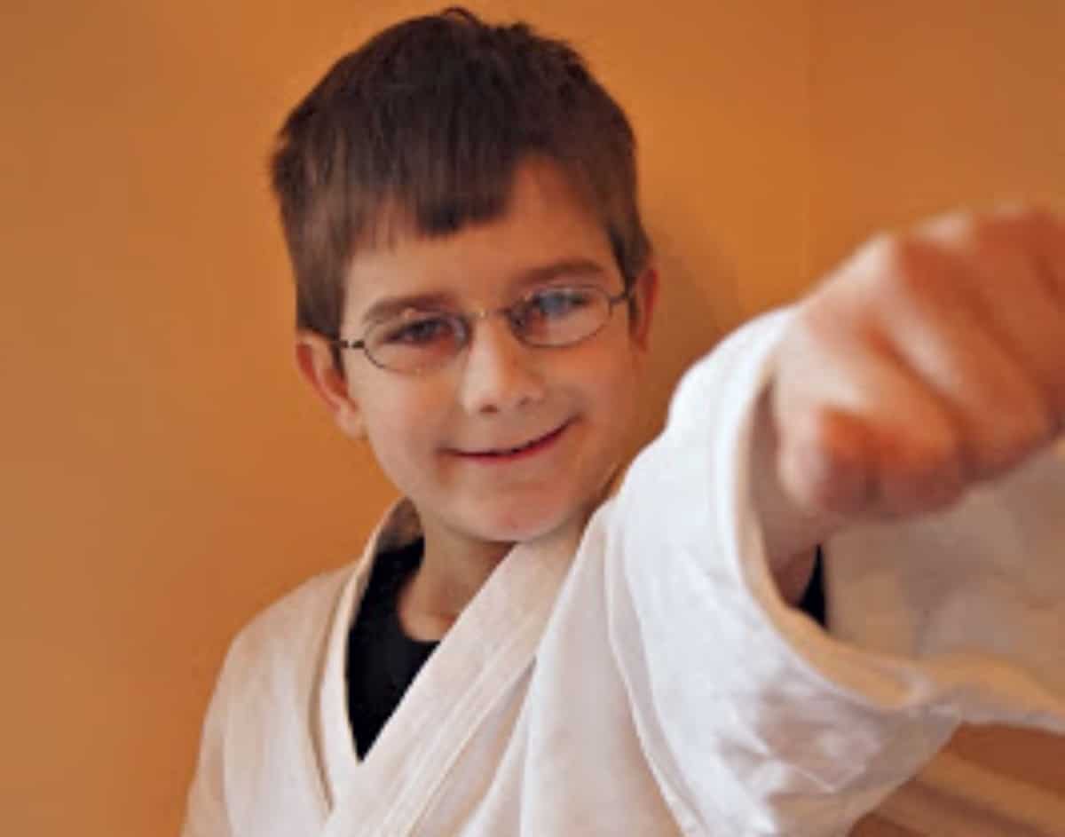 Boy doing a tae kwon do punch.