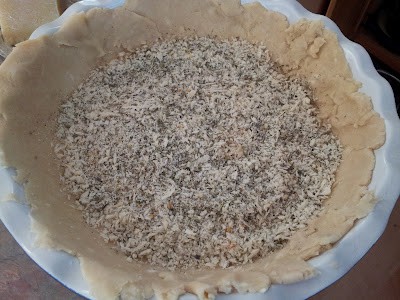 Bread crumbs mixed with herbs and parmesan cheese inside a pie crust.