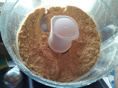 Overhead shot of graham cracker crumbs in a food processor.