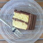 Overhead of a slice of yellow cake with chocolate frosting