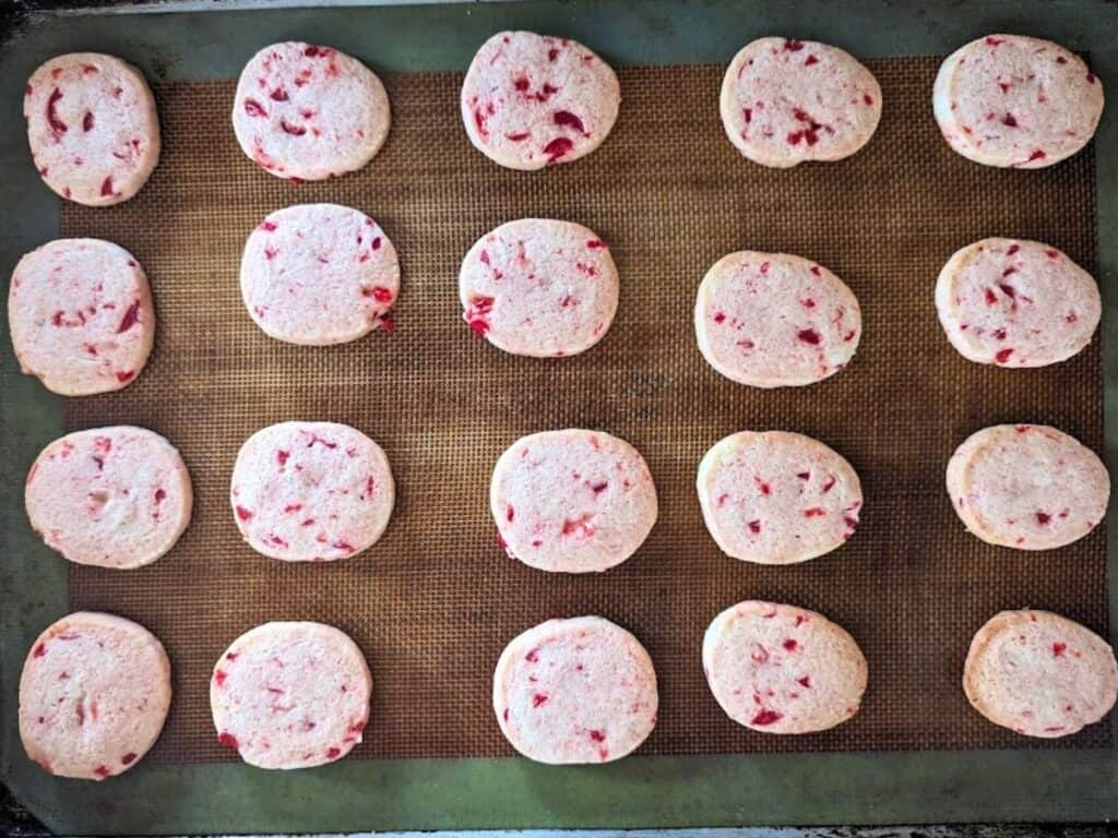 Image shows sugar cookies on a silpat.