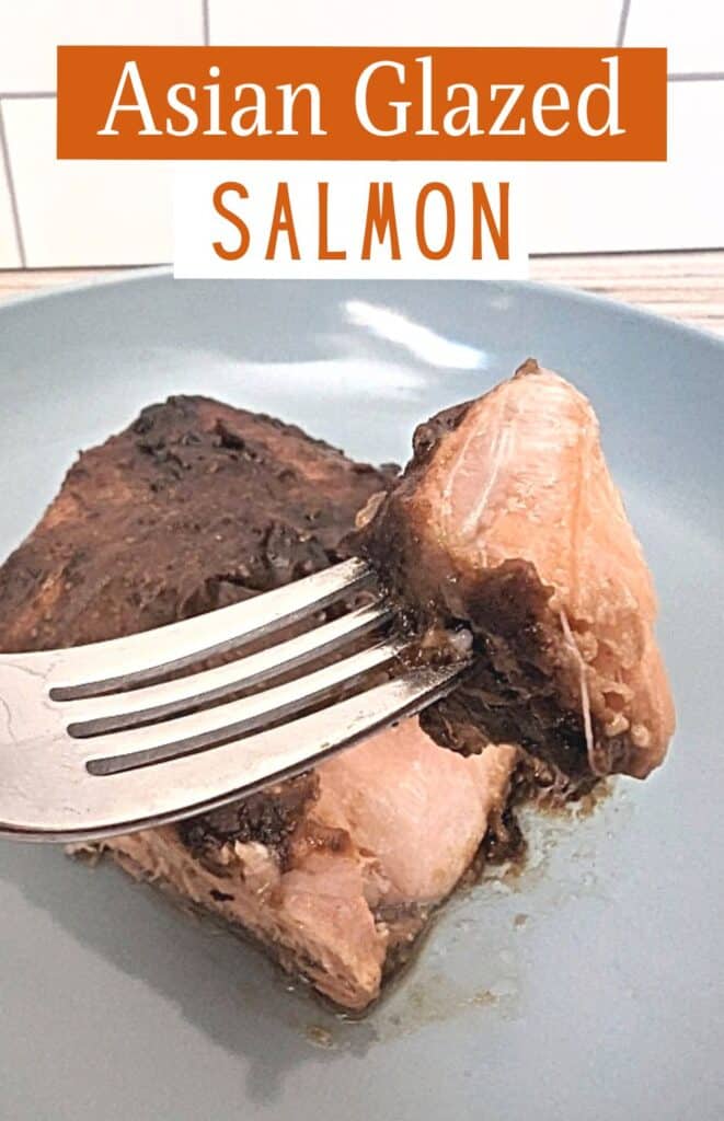 Fork holding a bite of glazed salmon with text asian glazed salmon.