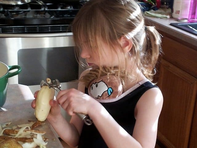 Little Miss peeling potatoes
