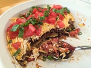Image shows bite of nontraditional 7 layer dip.