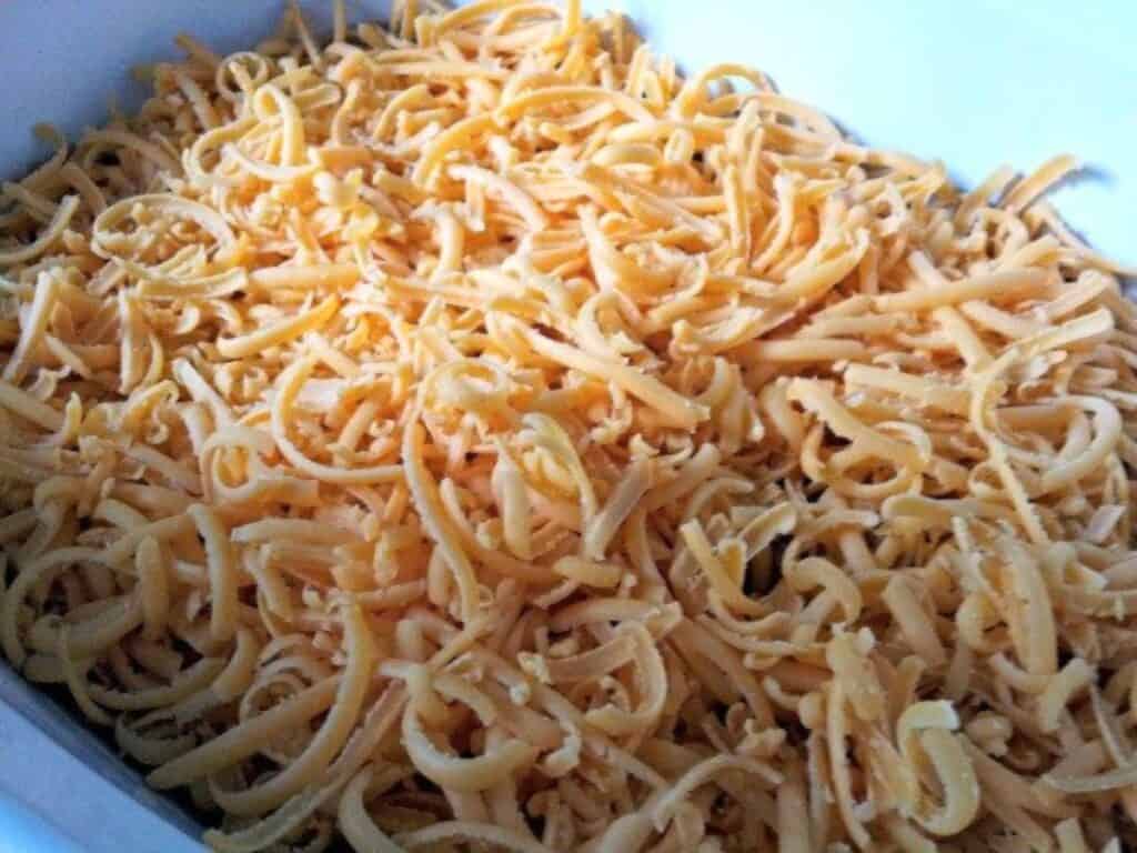 Image shows cheese layer above the refried bean base.