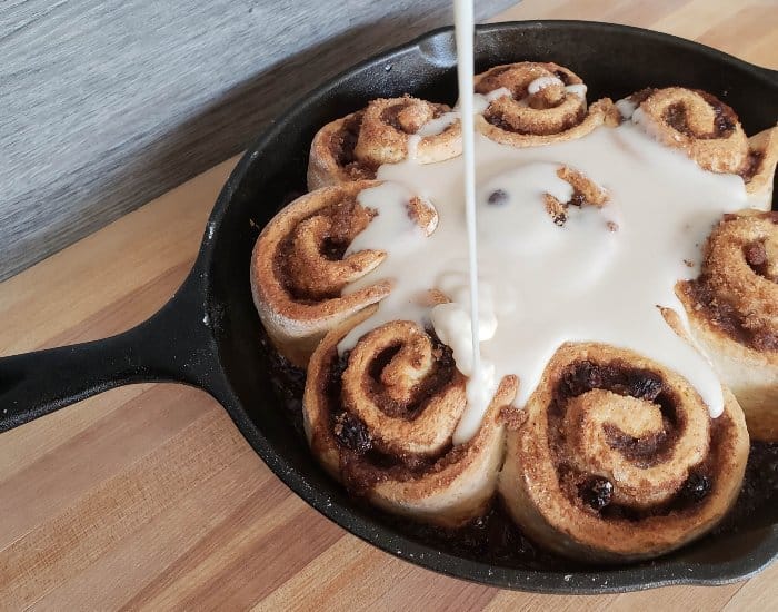 Add icing to cinnamon rolls