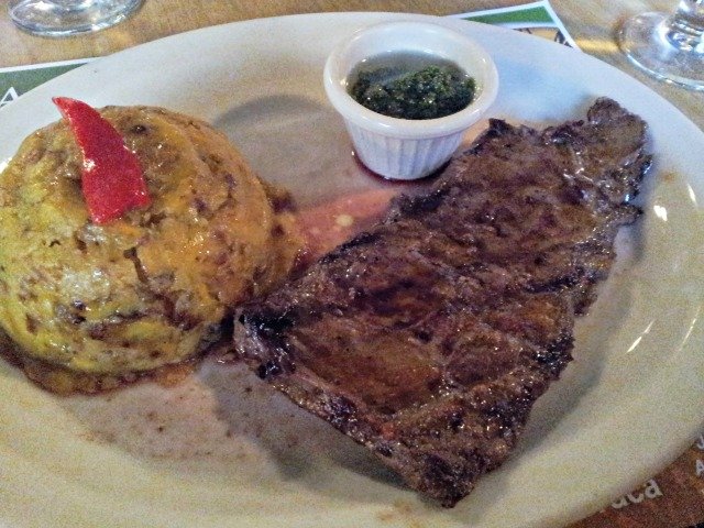 Restaurant plate of churrasco with mofongo
