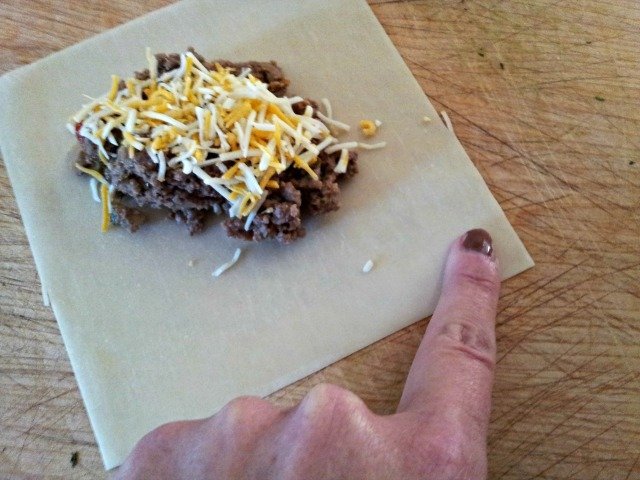 Dip your finger in water then trace the edge of the wonton wapper to moisten