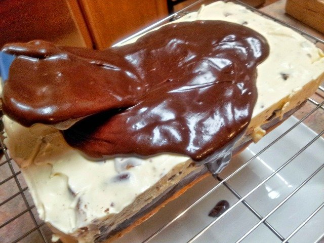 Spreading ganache atop the ice cream cake